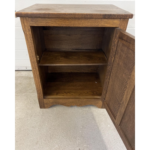 1282 - A vintage dark oak cupboard with brass knob handle and interior shelf. Panelled door with push catch... 