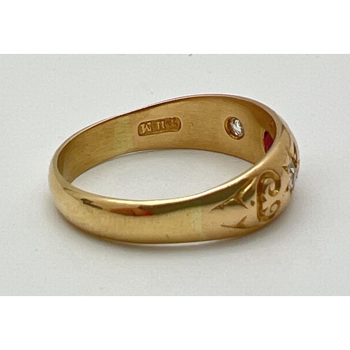 1012 - An 18ct gold gypsy style ring set with a central garnet and 2 diamonds. Stones set with claws and in... 