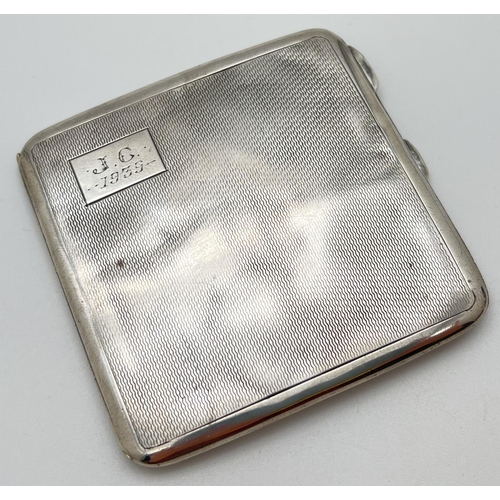 1124 - A vintage silver cigarette case with engine turned decoration to front and back. Square cartouche to... 