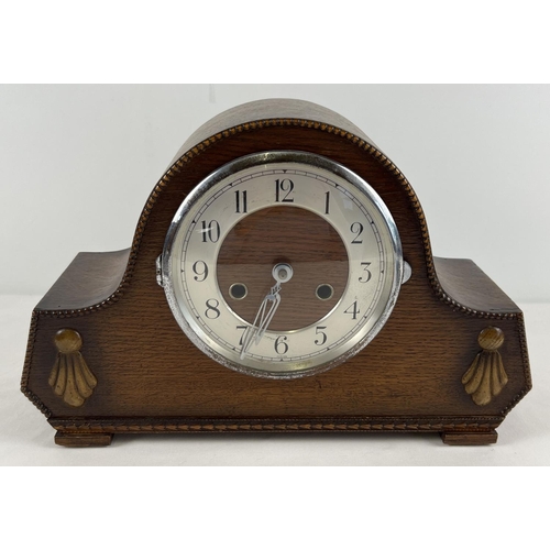 1160 - A vintage dark oak cased striking mantel clock with embossed beading and detail to front. Complete w... 