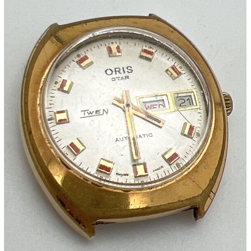 1106 - A vintage Oris Star Twen automatic watch with date and day function. Gold plated case with red and g... 