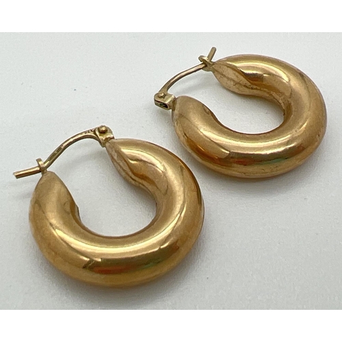 1007 - A pair of 9ct yellow gold hooped earrings with hinged posts. Posts stamped 375, outer diameter appro... 