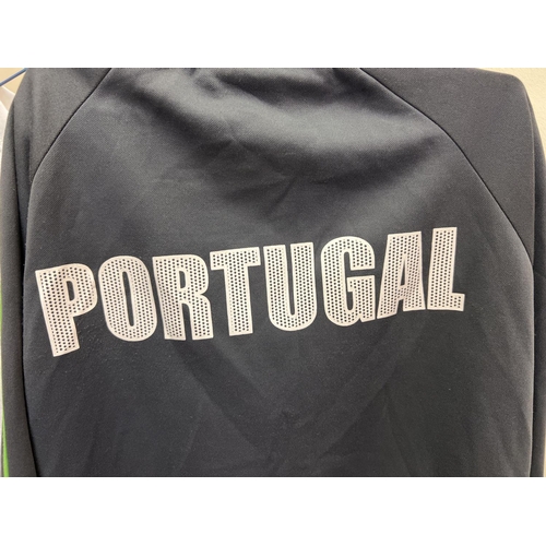 1221 - A Portugal FC zip up long sleeved sports top - size S, together with a Le Coq Sportif short sleeved ... 