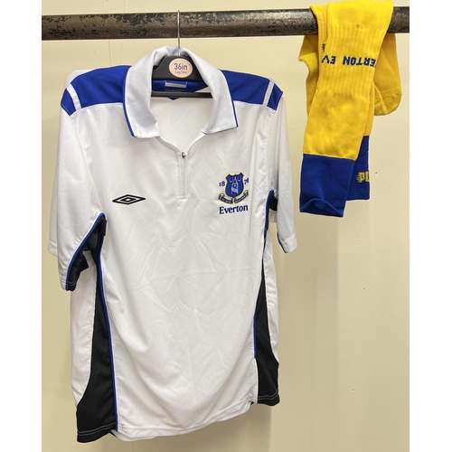 1223 - An Everton FC white football shirt with zip collar fastening, size M. Together with a pair of yellow... 