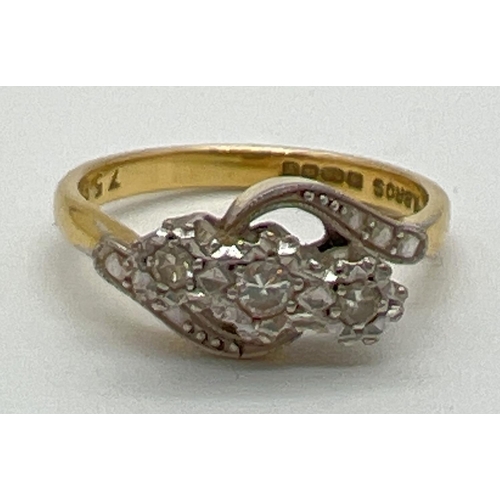 1039 - A vintage 18ct gold and diamond trilogy ring in a twist setting. With illusion design twist shoulder... 