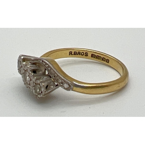 1039 - A vintage 18ct gold and diamond trilogy ring in a twist setting. With illusion design twist shoulder... 