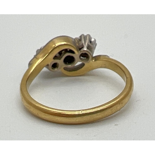 1039 - A vintage 18ct gold and diamond trilogy ring in a twist setting. With illusion design twist shoulder... 