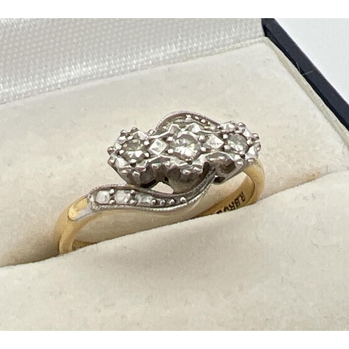 1039 - A vintage 18ct gold and diamond trilogy ring in a twist setting. With illusion design twist shoulder... 