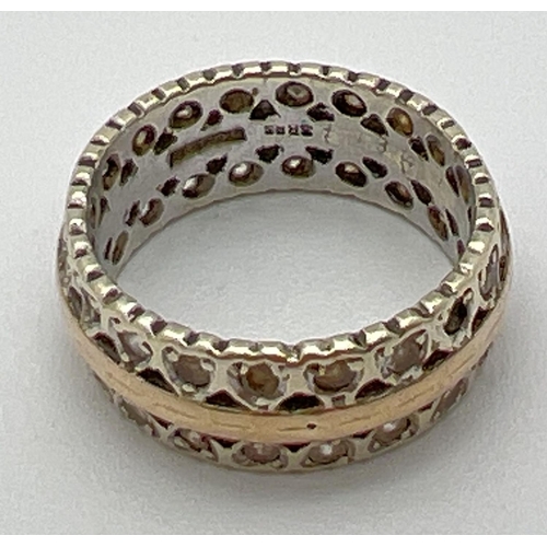 1044 - A vintage duo coloured 9ct gold full eternity ring with heart decoration, set with multiple clear st... 