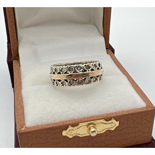 1044 - A vintage duo coloured 9ct gold full eternity ring with heart decoration, set with multiple clear st... 