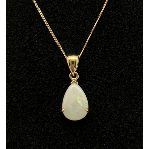 1045 - A teardrop shaped opal pendant on a 9ct gold fine 16