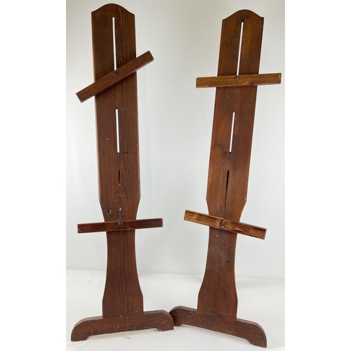 1255 - 2 wooden easel style display stands with folding foot/stand. With height adjustable supports. Each a... 