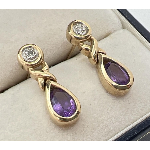 1002 - A pair of modern design 9ct gold amethyst and diamond set drop style earrings. Each set with a small... 