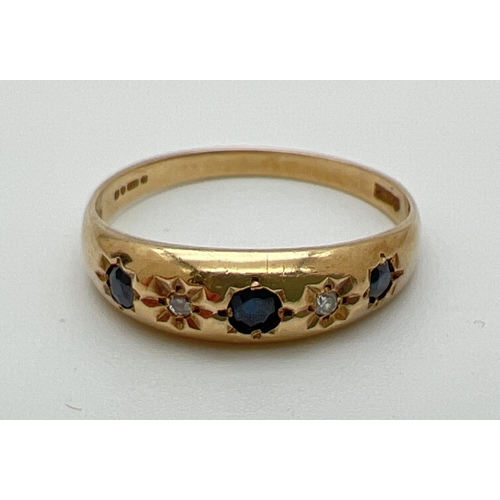 1061 - A vintage 9ct gold diamond and sapphire Gypsy style dress ring. Set with 3 blue sapphires and 2 diam... 