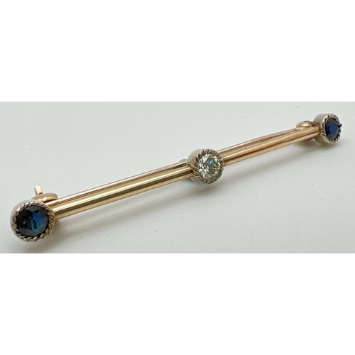 1003 - A vintage design 9ct gold bar brooch set with 2 round cut sapphires and a round cut diamond. Each st... 