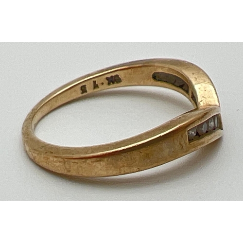 1066 - A 9ct gold wishbone dress ring with 9 channel set small round cut diamonds, total ct. 0.15. Full hal... 