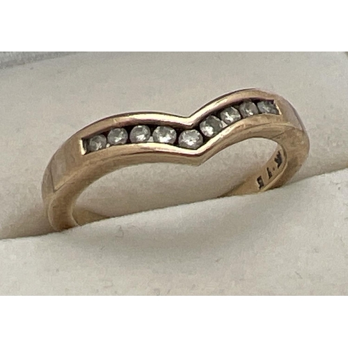 1066 - A 9ct gold wishbone dress ring with 9 channel set small round cut diamonds, total ct. 0.15. Full hal... 