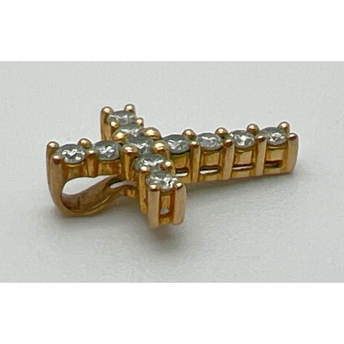 1068 - A small diamond set 9ct gold cross shaped pendant. Diamond total .25ct. Full hallmarks and diamond c... 