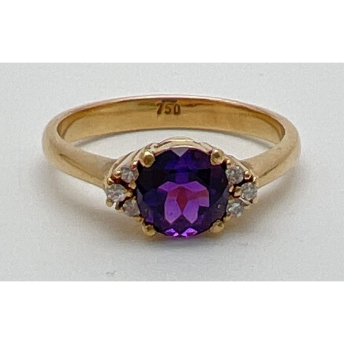 1069 - An 18ct gold amethyst and diamond dress ring. 
A central round cut .75ct amethyst with 3 small round... 