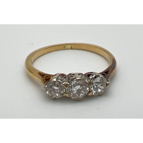 1070 - A vintage 18ct gold .60ct diamond trilogy ring. Worn marks to inside of band but tests as 18ct. Ring... 