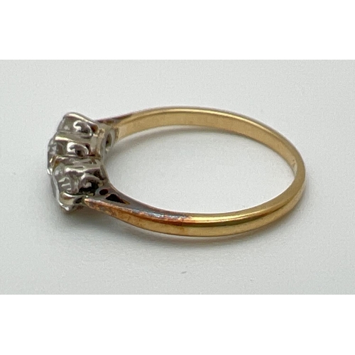 1070 - A vintage 18ct gold .60ct diamond trilogy ring. Worn marks to inside of band but tests as 18ct. Ring... 