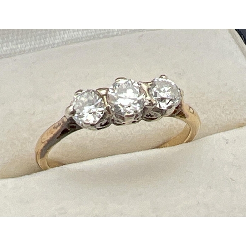 1070 - A vintage 18ct gold .60ct diamond trilogy ring. Worn marks to inside of band but tests as 18ct. Ring... 