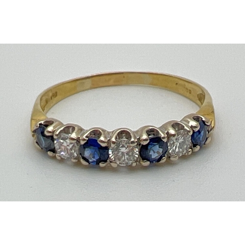 1013 - An 18ct gold sapphire and diamond half eternity style dress ring. Alternating blue sapphires and dia... 