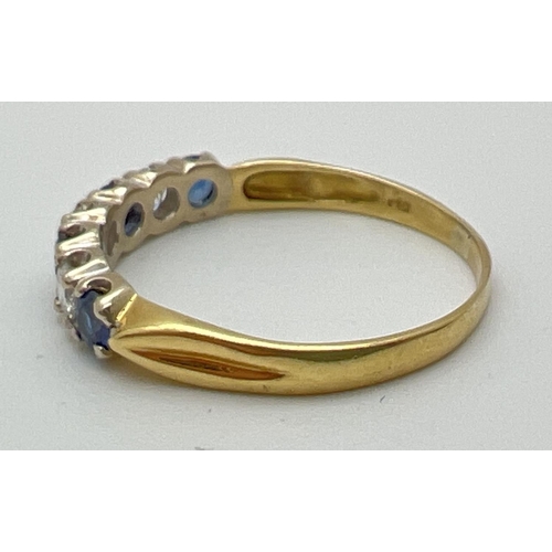 1013 - An 18ct gold sapphire and diamond half eternity style dress ring. Alternating blue sapphires and dia... 