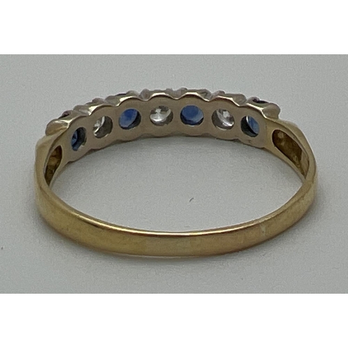 1013 - An 18ct gold sapphire and diamond half eternity style dress ring. Alternating blue sapphires and dia... 