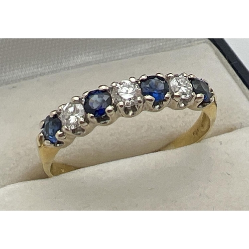 1013 - An 18ct gold sapphire and diamond half eternity style dress ring. Alternating blue sapphires and dia... 