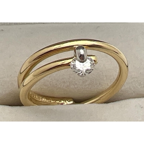 1073 - A contemporary design 18ct gold and platinum dress ring with tension set 0.20ct diamond. Makers name... 