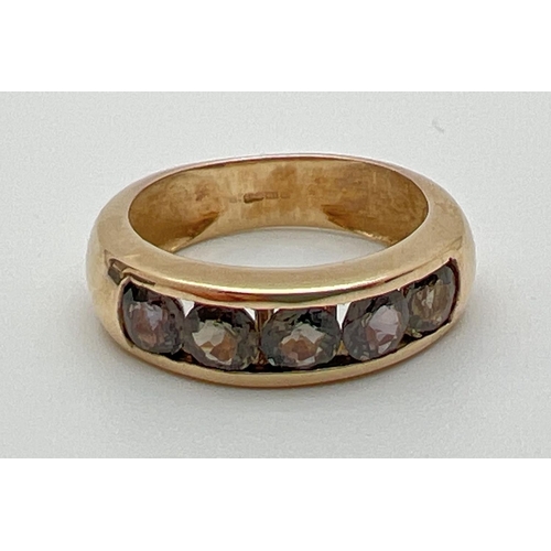 1074 - A modern design 9ct gold and channel set Alexandrite half eternity style ring. 5 round cut stones wi... 