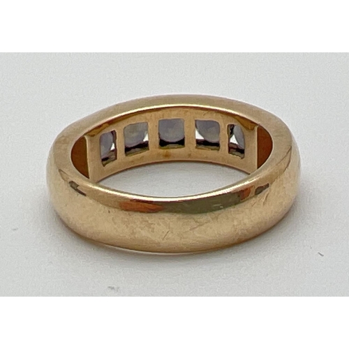 1074 - A modern design 9ct gold and channel set Alexandrite half eternity style ring. 5 round cut stones wi... 