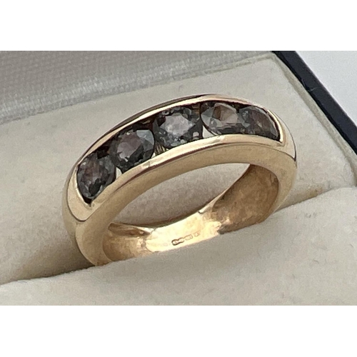 1074 - A modern design 9ct gold and channel set Alexandrite half eternity style ring. 5 round cut stones wi... 