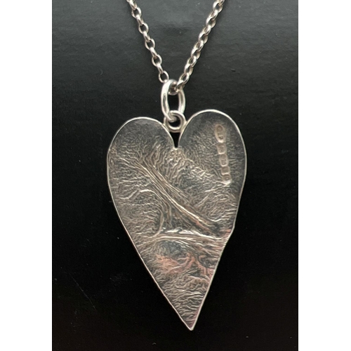 1081 - A modern design heart shaped pendant on an 18 inch belcher chain with lobster clasp. Full hallmarks ... 