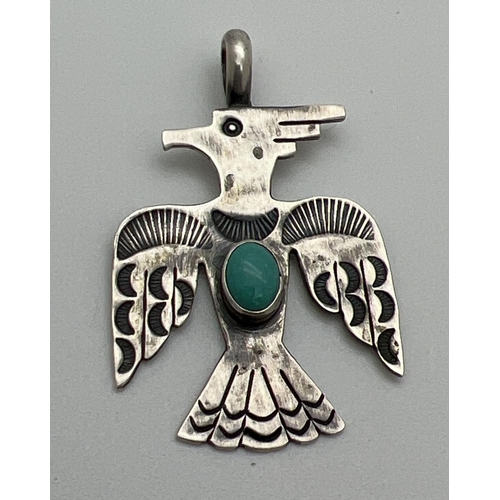 1083 - A Native American design silver pendant of an eagle set with a cabochon of turquoise. Markers mark a... 