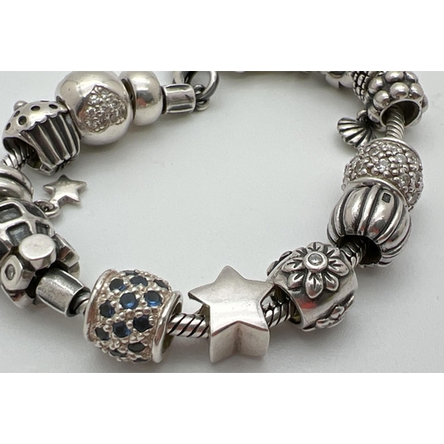 1093 - A Lovelinks style silver charm bracelet with lobster style clasp and 18 charms/beads. Beads include ... 