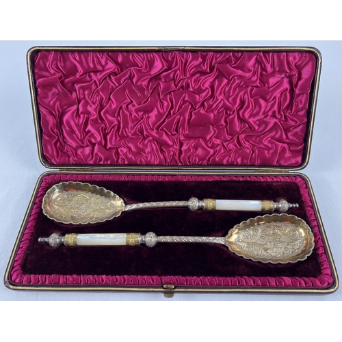 1131 - A pair of late Victorian silver plated serving spoons with gilt bowls and mother of pearl handles. D... 