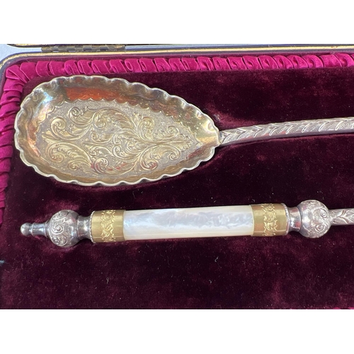 1131 - A pair of late Victorian silver plated serving spoons with gilt bowls and mother of pearl handles. D... 