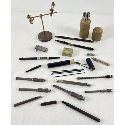 1118 - A collection of vintage watch makers tools. To include a French brass Helping Hands stand, drill han... 