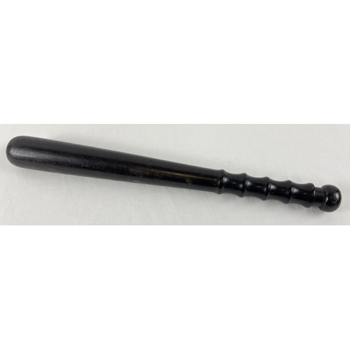 1152 - A vintage ebonised wooden truncheon. With shaped grip handle. Approx 38.5cm.