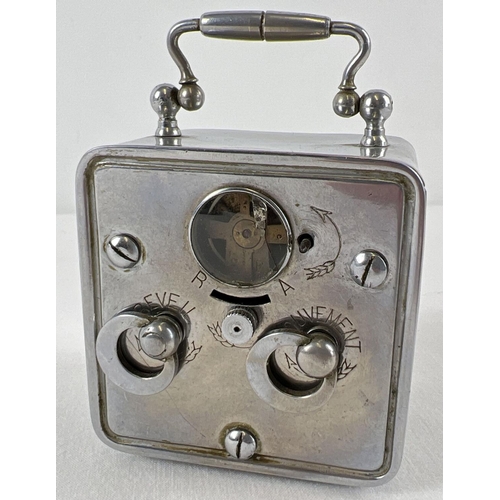 1162 - An antique wind up bedside alarm clock with enamelled face and bevel edged glass. A small silver pla... 