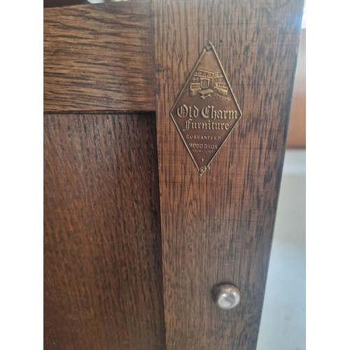 1291 - A vintage medium oak Old Charm court cupboard with Gothic style metal drop down handles & hinges. Tr... 