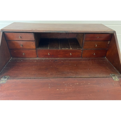 1293 - A Georgian mahogany 4 drawer bureau with drop down handles, brass lock and interior stationery drawe... 