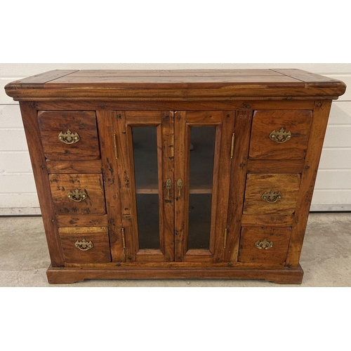 1295 - A heavy Indian rubber wood sideboard with 2 central glass panelled doors & 6 small drawers. Central ... 