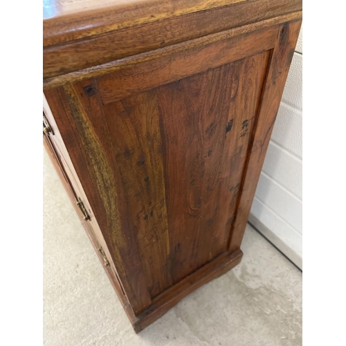 1295 - A heavy Indian rubber wood sideboard with 2 central glass panelled doors & 6 small drawers. Central ... 