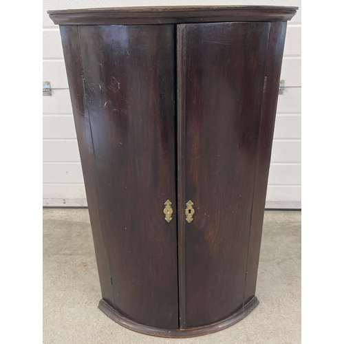 1300 - A Georgian mahogany curve fronted corner cupboard with oak interior shelves (top shelf shaped). Appr... 