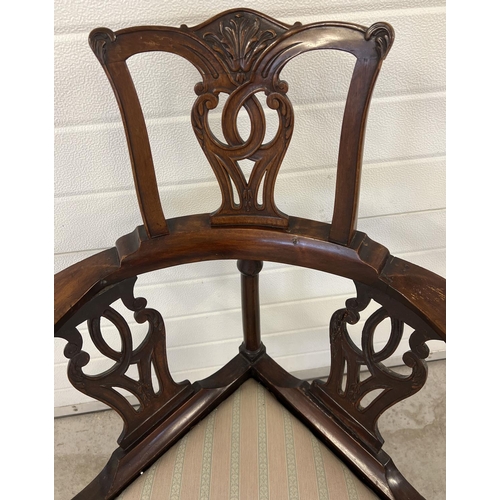 1304 - An Edwardian Chippendale style high back corner chair with carved detail. Decoratively shaped suppor... 