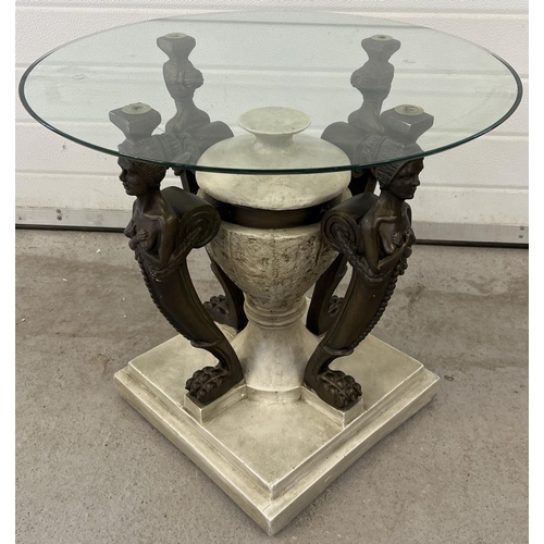 1309 - A modern circular glass topped coffee table of classical design. Heavy resign base with central urn ... 