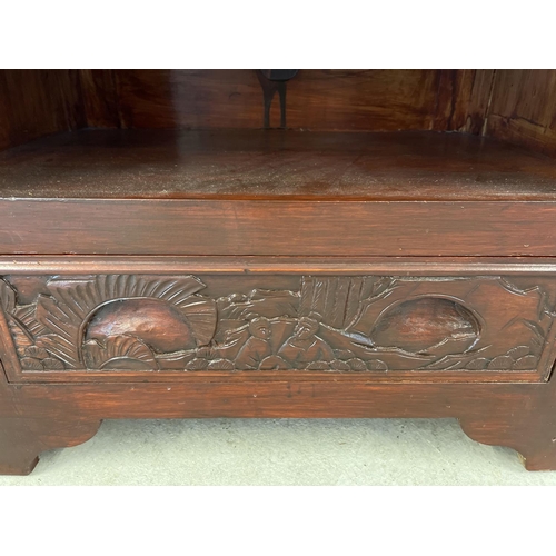 1311 - A vintage Chinese style unit with painted red mahogany effect and carved detail. Open shelf to front... 